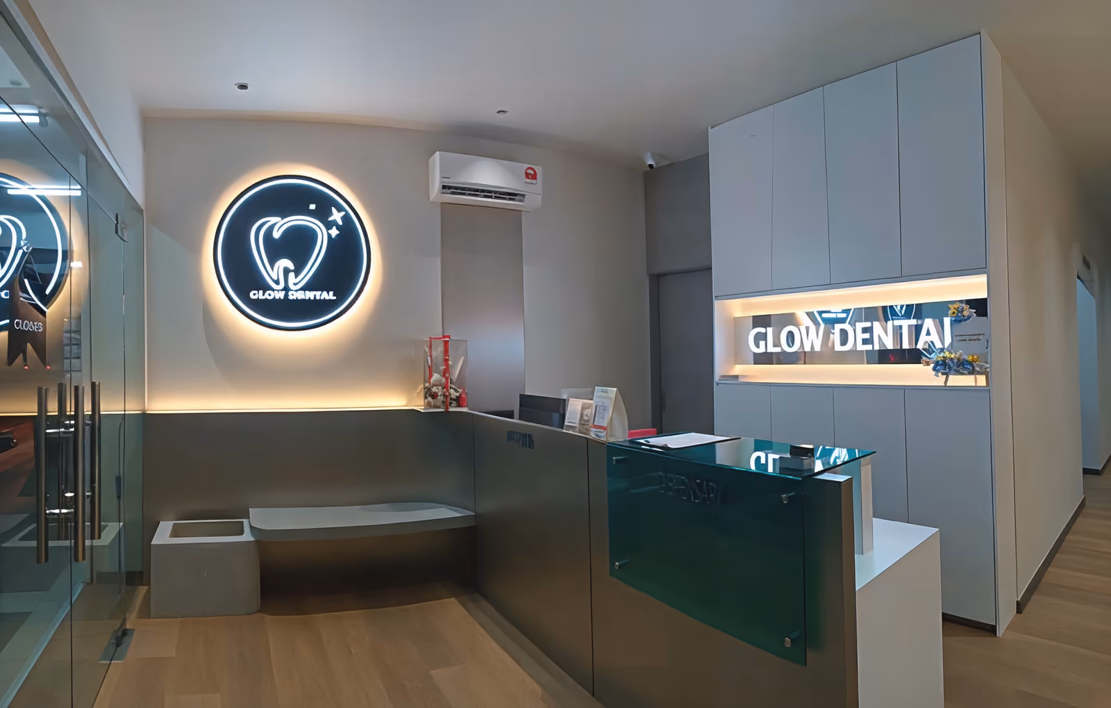 Welcoming reception at Glow Dental Clinic in Bintulu with illuminated GLOW DENTAL tooth logo
